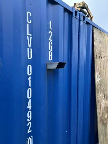 Original rear-facing flue outlet on container housing a Nilfisk Truck Booster before vertical chimney installation in Lichfield.